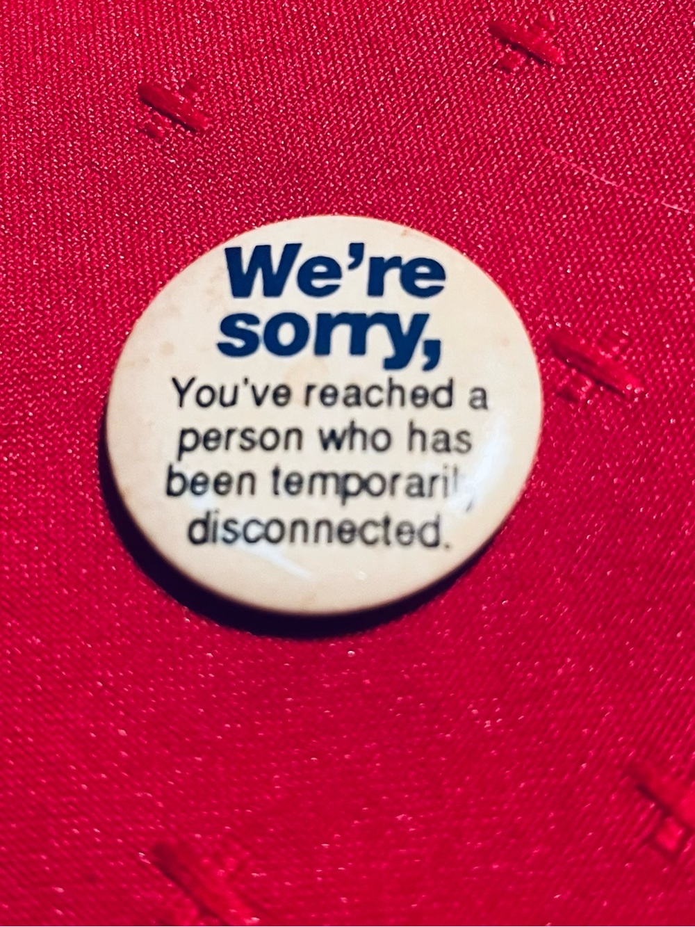 White Message Button Pin — 'We're Sorry' Novelty Lapel Accessory